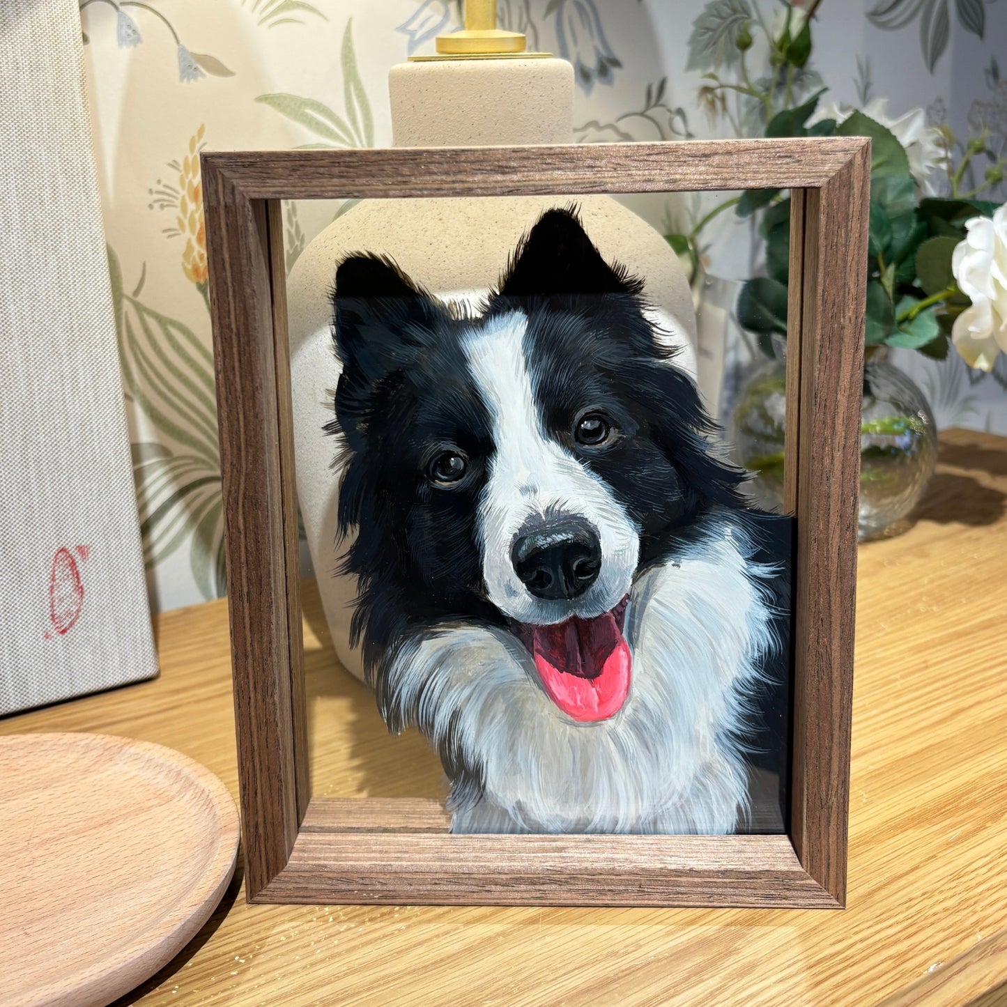 Custom pet portrait framed in glass sandwich frame — front view of finished artwork with decorative background